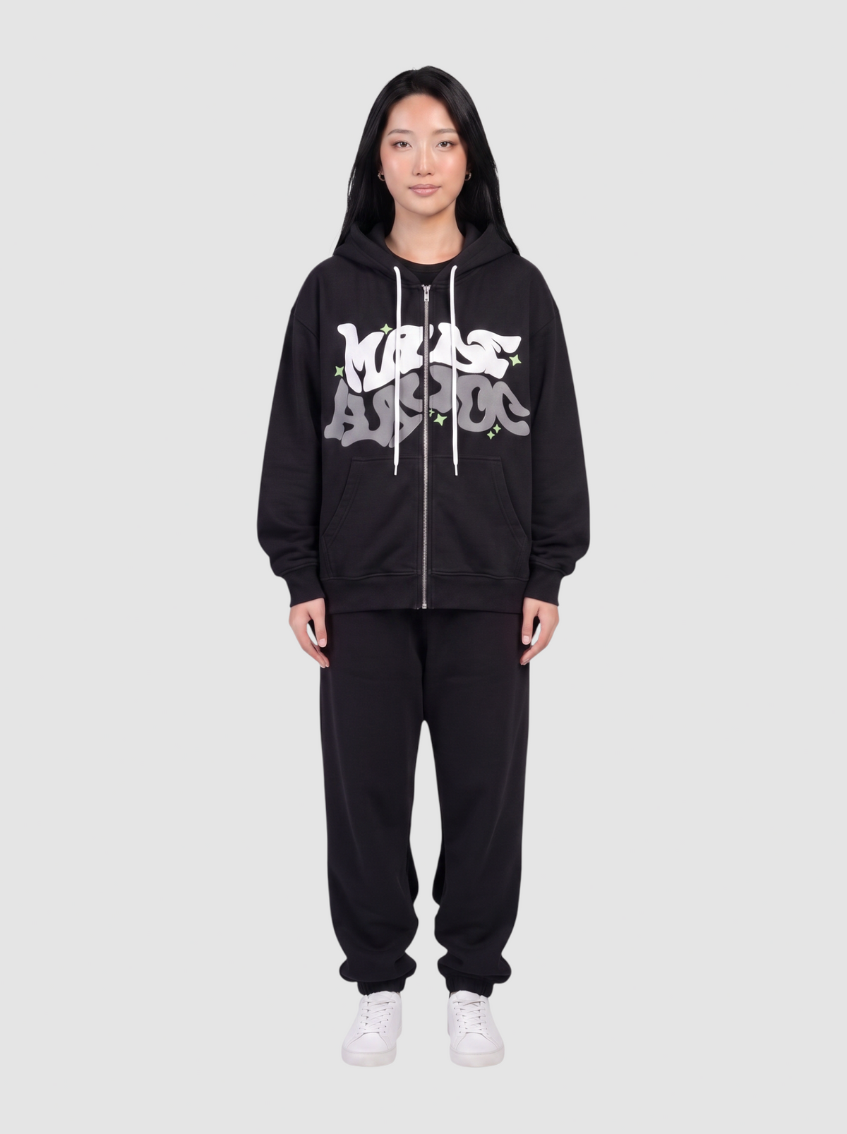 Y2K Avenue black zip-up hoodie featuring white and grey bubble graffiti lettering and green star accents on a model.