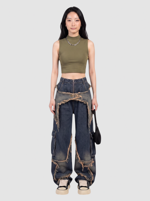 Model wearing Y2K Avenue baggy cargo jeans with frayed denim overlays and a high-waisted indigo wash design.