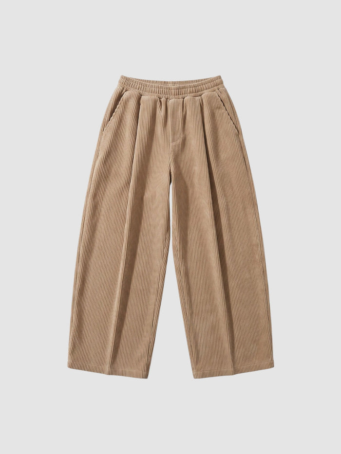 Pantalon en velours côtelé beige jambe large avec taille élastiquée et poches profondes sur le côté, style Y2K décontracté.