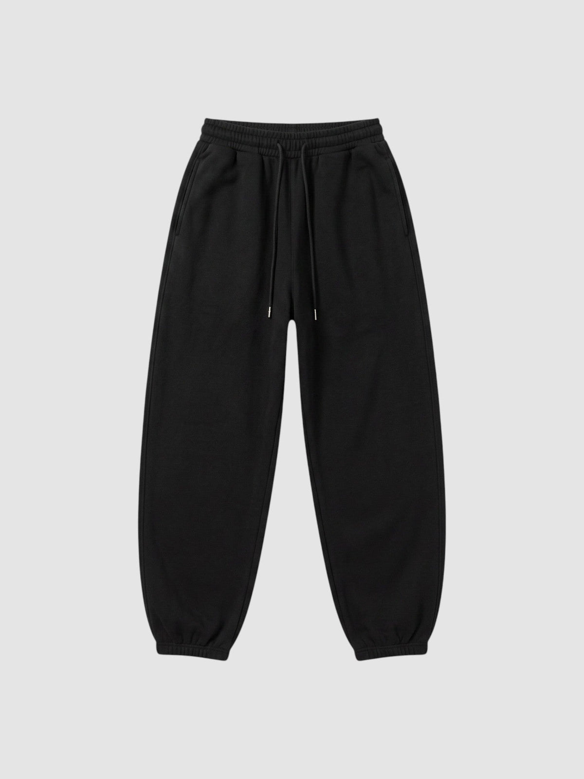 Jogging barrel noir avec taille haute élastiquée, cordon de serrage et poches profondes sur le côté.