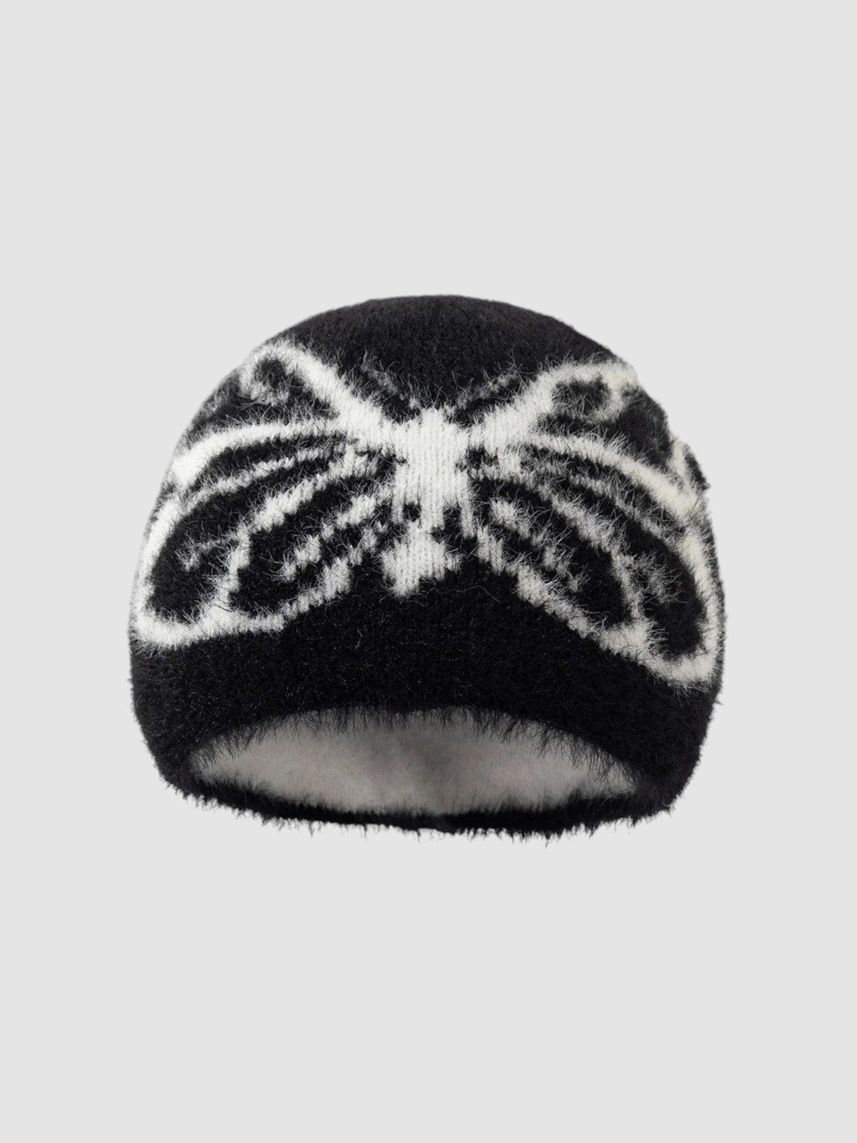 Bonnet Papillon noir et blanc duveteux avec motif ailes de papillon, texture douce et pelucheuse.