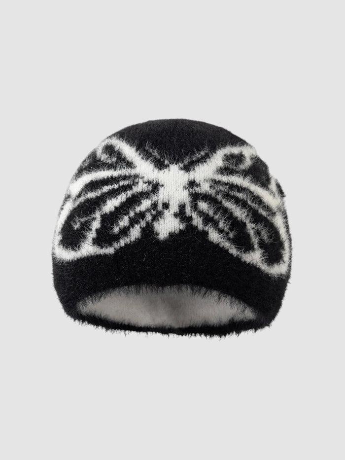 Bonnet Papillon noir et blanc duveteux avec motif ailes de papillon, texture douce et pelucheuse.