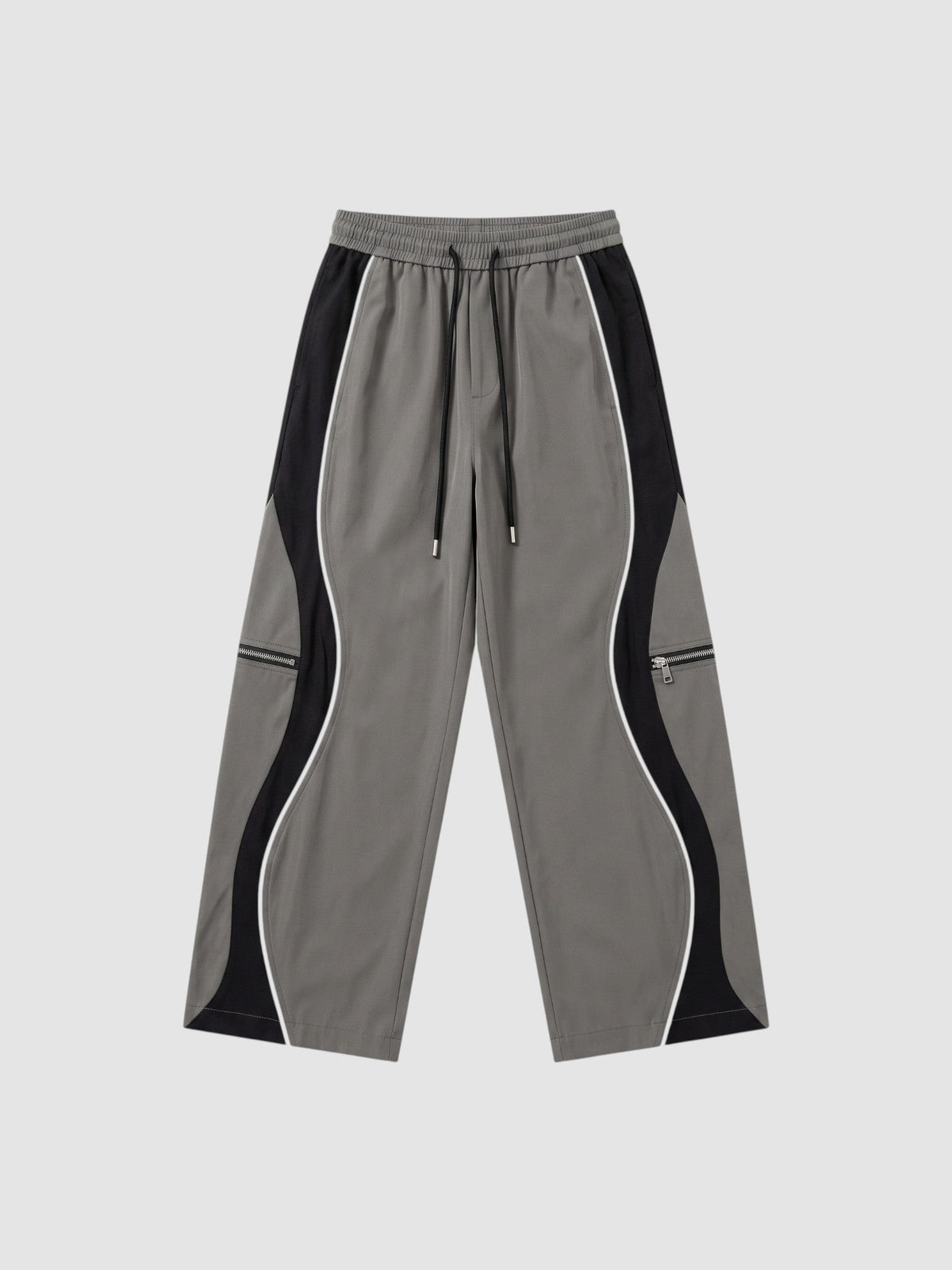 Pantalon Y2K à panneaux gris et noir avec liseré blanc, fermetures éclair décoratives et cordons de cheville ajustables.