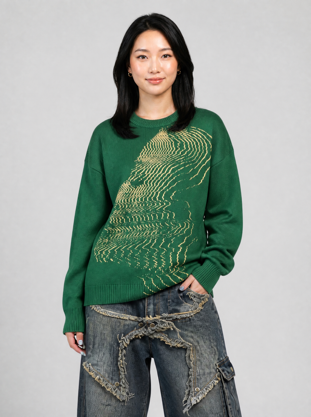 Autre vue | Femme de face en pull maille vert à motif visage glitch crème, portée avec un jean baggy bleu à étoiles effilochées
