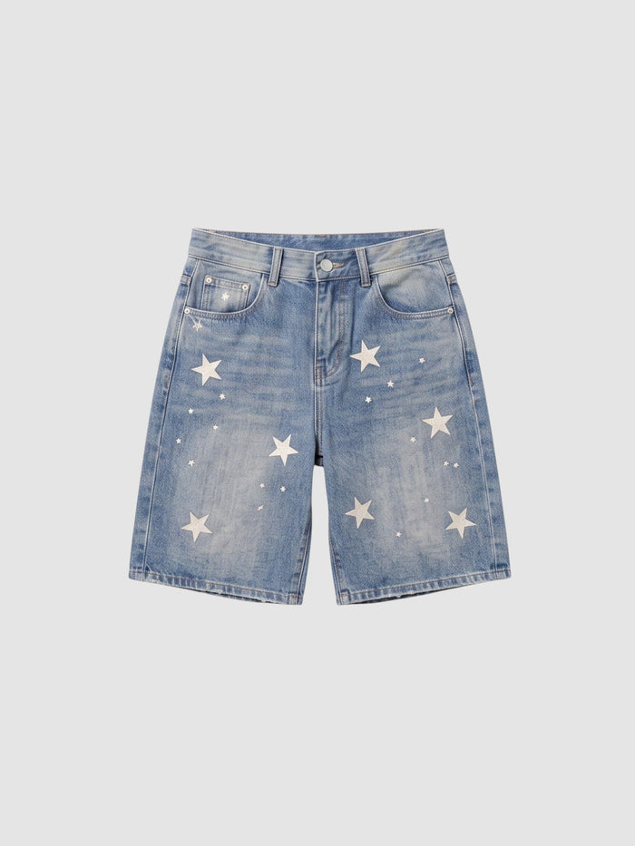 Short en denim bleu clair taille haute avec imprimés étoiles blanches éparpillées et coupe droite décontractée.