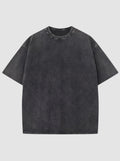 T-shirt noir délavé vintage en coton, coupe décontractée, col rond et manches courtes.