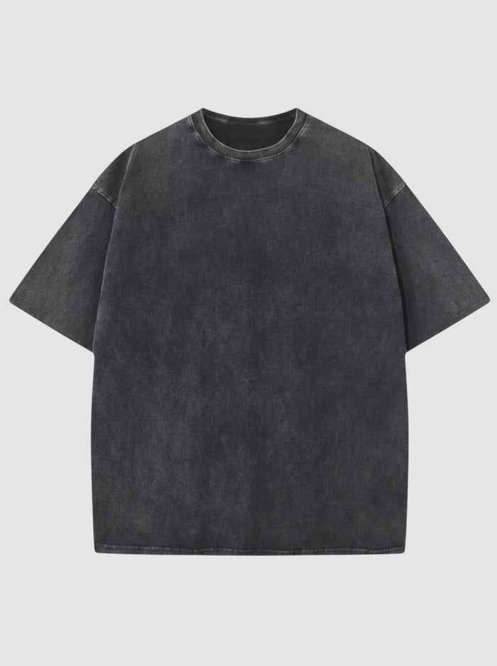 T-shirt noir délavé vintage en coton, coupe décontractée, col rond et manches courtes.