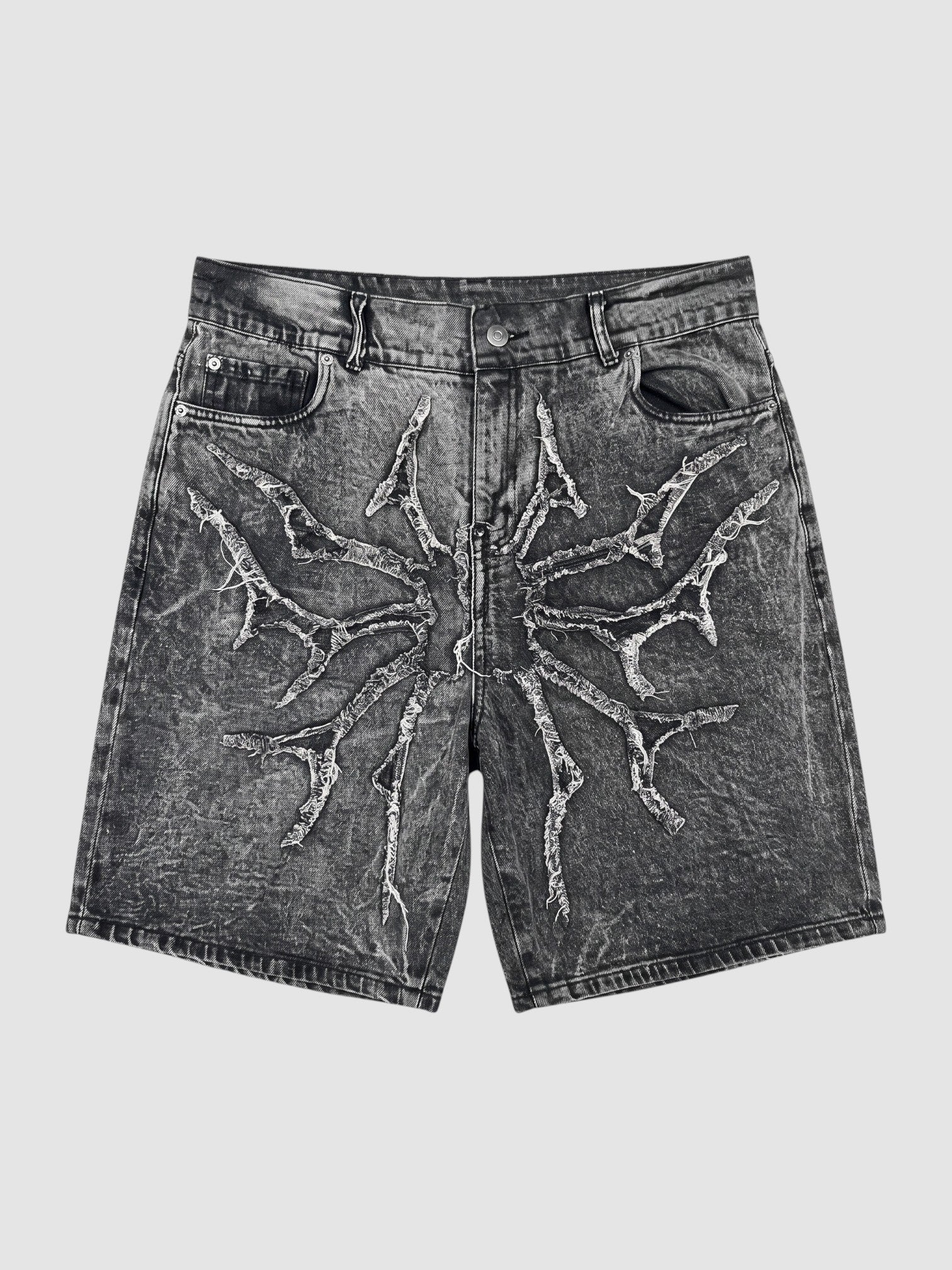 Y2K Avenue acid wash black denim jorts featuring a distressed thorny star appliqué with raw frayed edges.