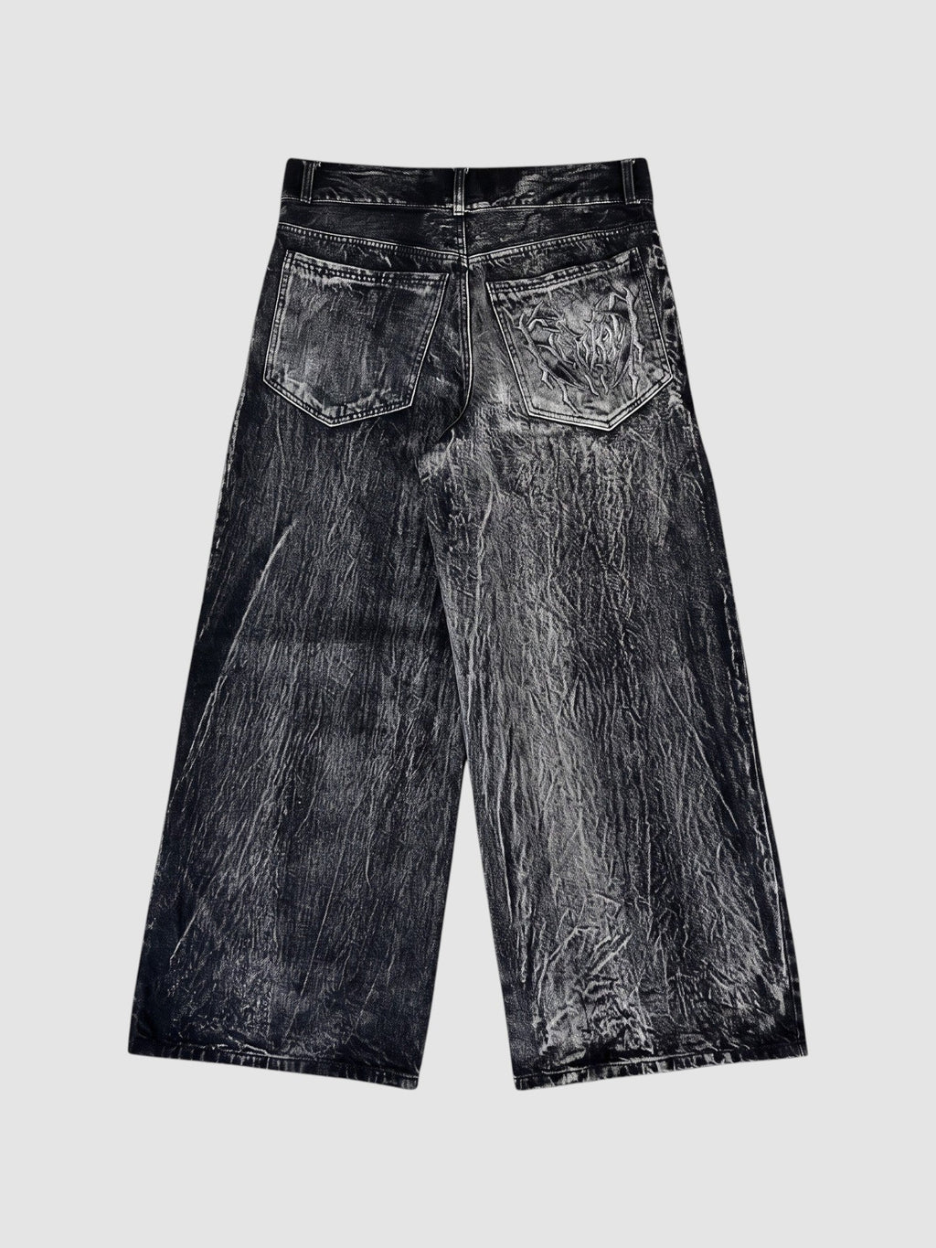 Y2K Avenue wide-leg acid wash black denim jeans with raw edge spiderweb appliqué detail on the back pockets
