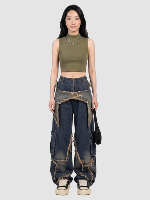 Model wearing Y2K Avenue baggy indigo cargo jeans with frayed denim overlays and a high-waisted fit