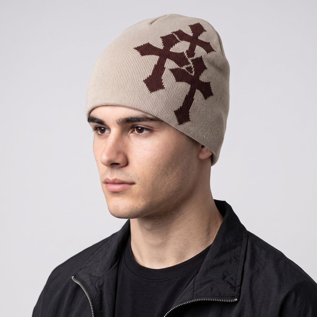 Y2K AVENUE beige acrylic knit beanie featuring a brown jacquard crucifix pattern worn by a male model