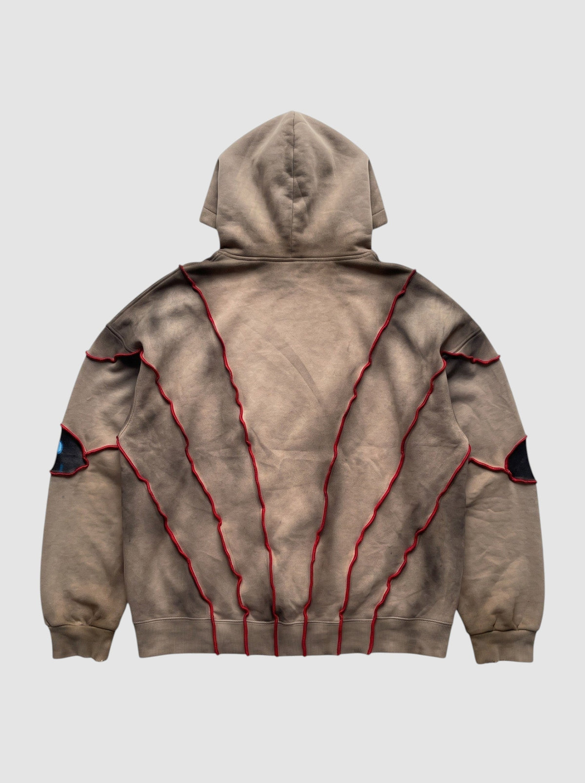 Back view of Y2K Avenue oversized beige faded hoodie with red raised seams and patchwork eye details