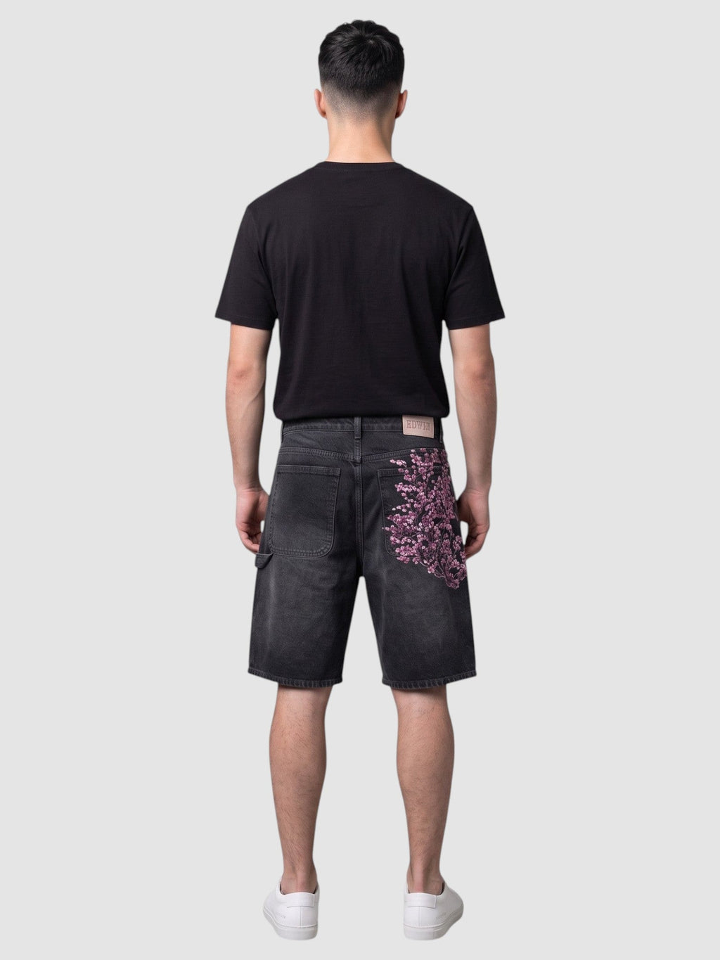 Y2K AVENUE black denim jorts with pink and white embroidered cherry blossom branch on the back pocket