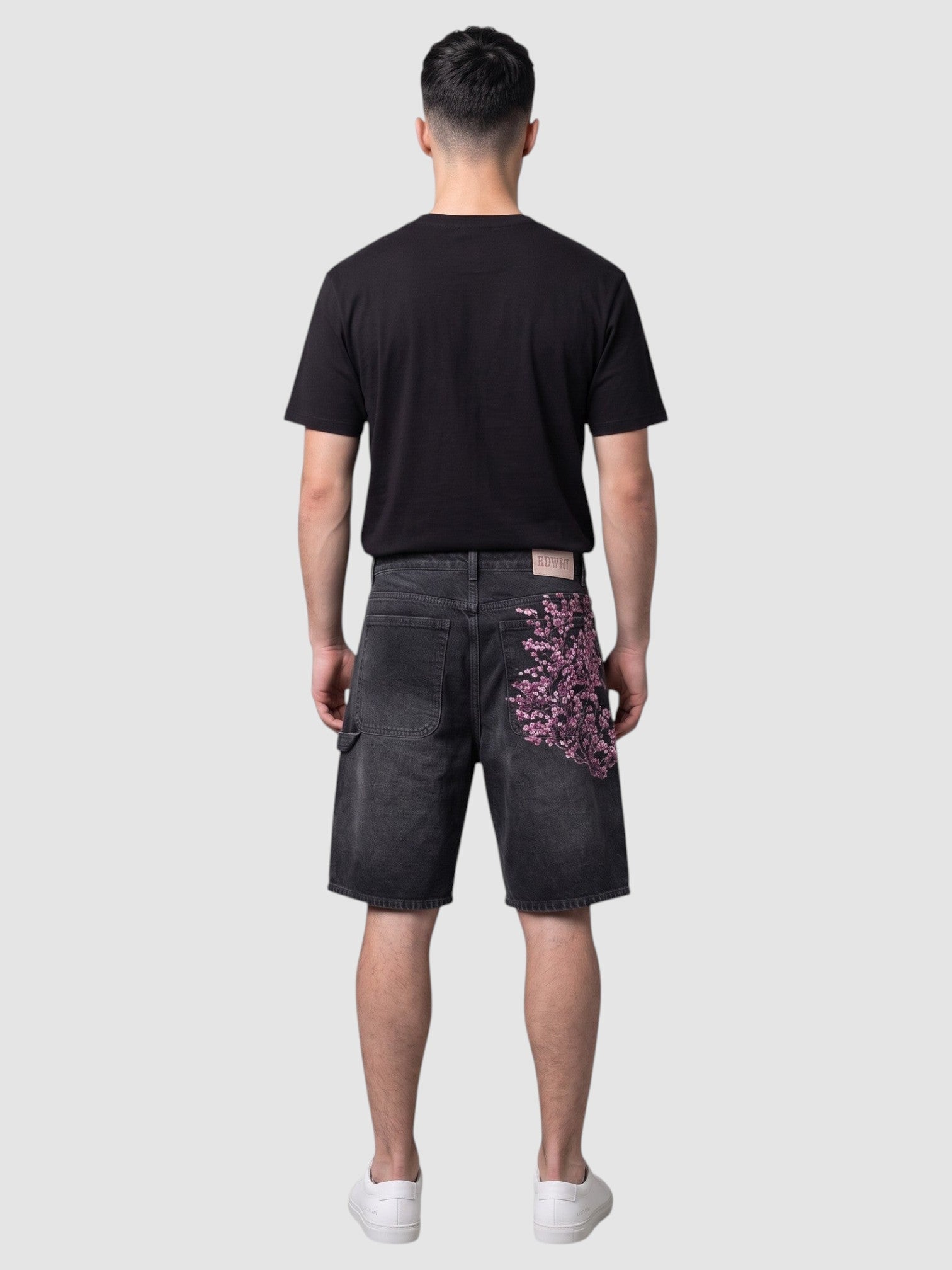 Y2K AVENUE black denim jorts with pink and white embroidered cherry blossom branch on the back pocket