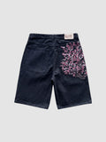 Y2K Avenue black denim jorts featuring intricate pink and white cherry blossom embroidery on the back pocket.
