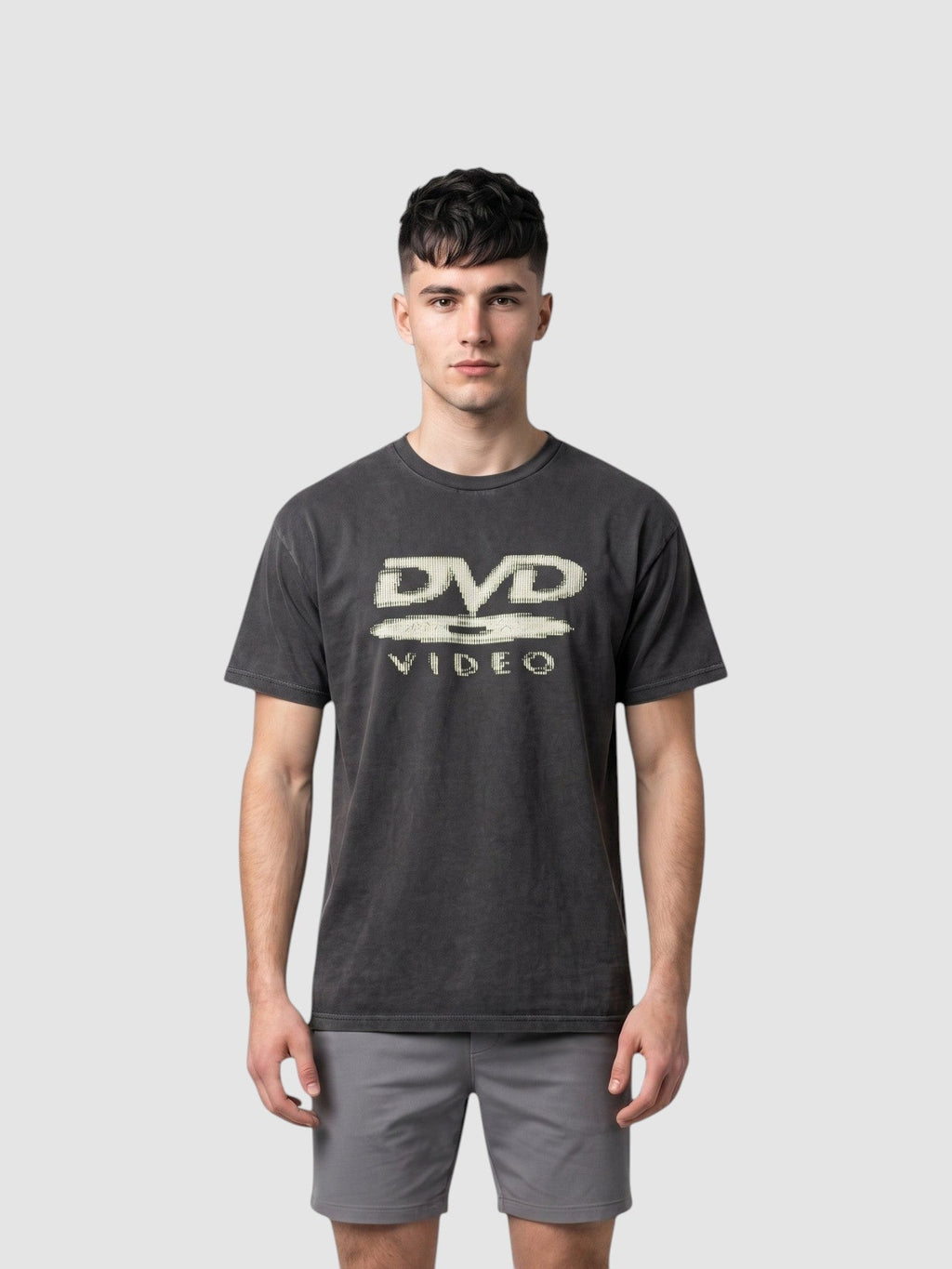 Y2K Avenue black washed polyester t-shirt featuring an ecru DVD Video logo print on the chest worn by a male model