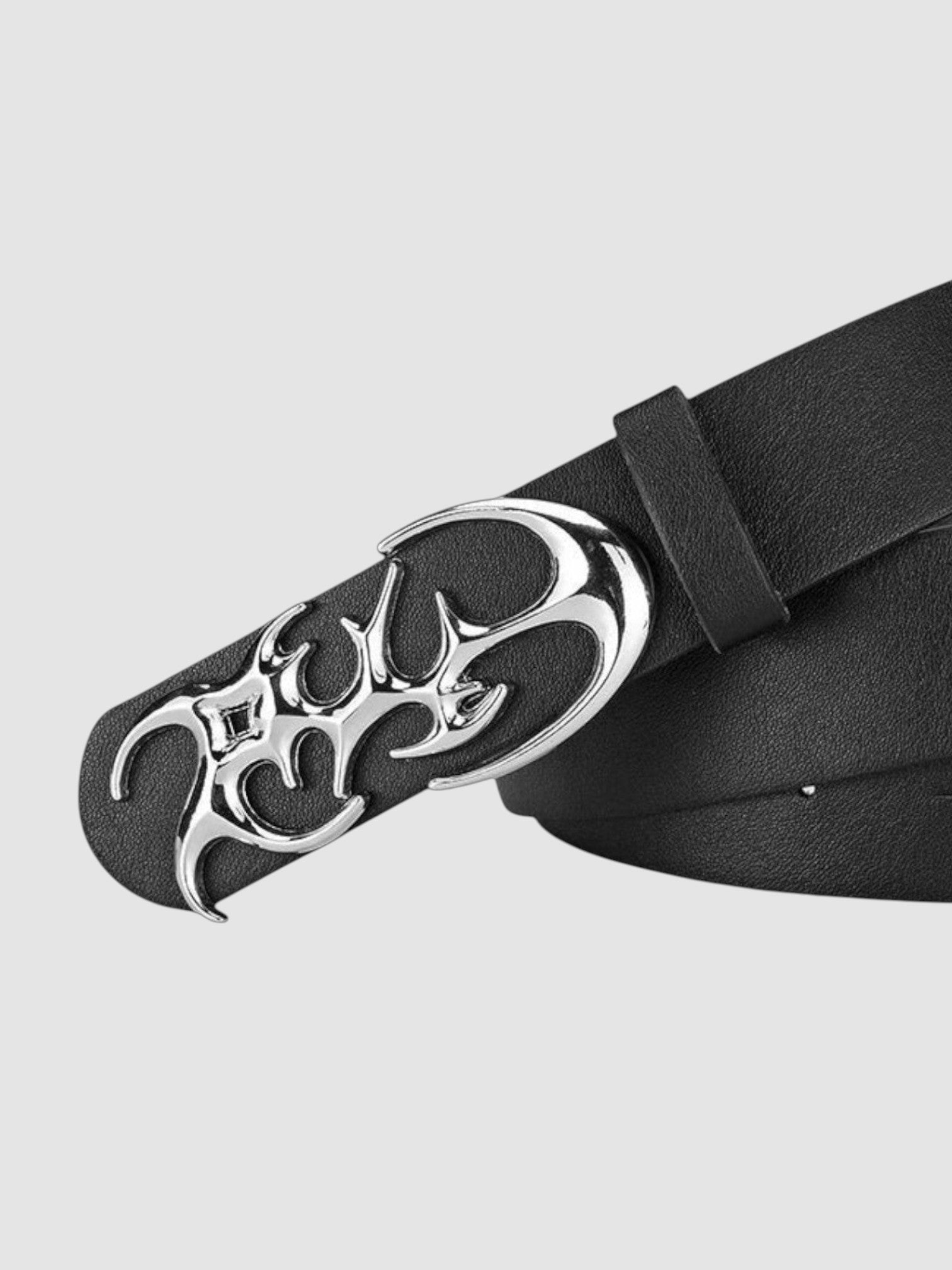 Y2K Avenue black faux leather belt featuring a shiny silver asymmetrical flame-shaped metal buckle