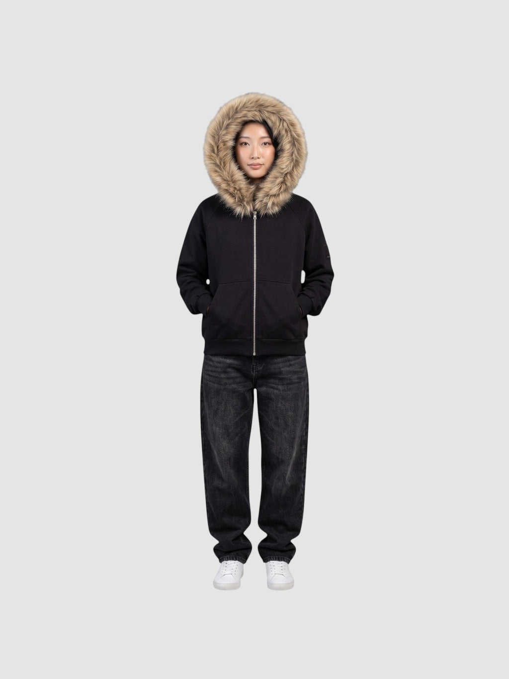Model wearing a Y2K Avenue black zip-up hoodie with a large beige faux fur hood trim and ribbed cuffs.