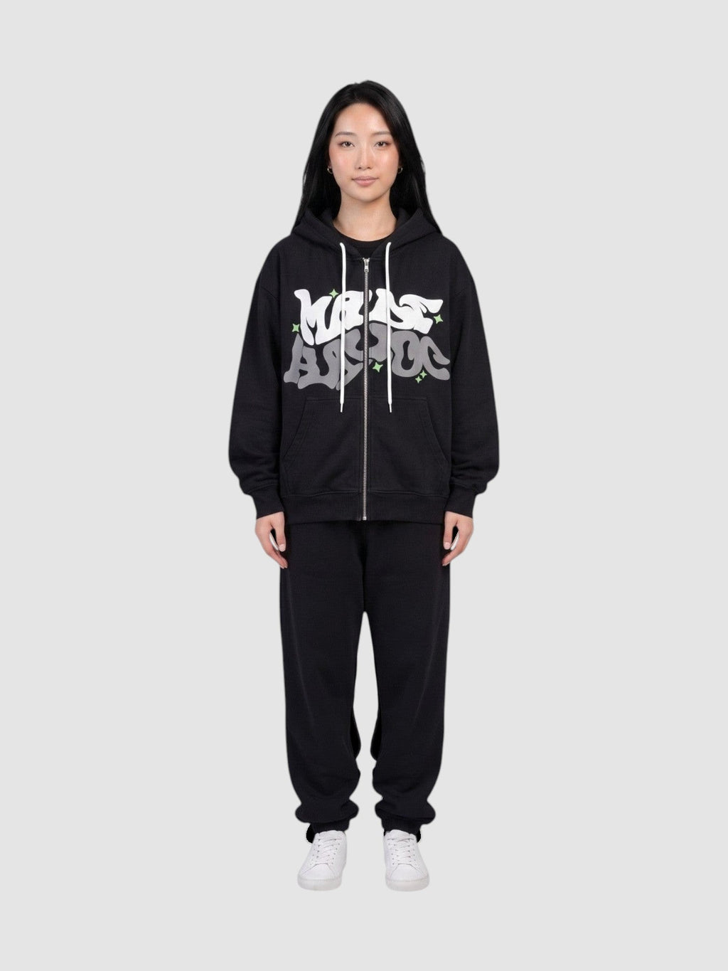 Y2K Avenue black zip-up hoodie with white and grey graffiti bubble lettering and green star accents on a model