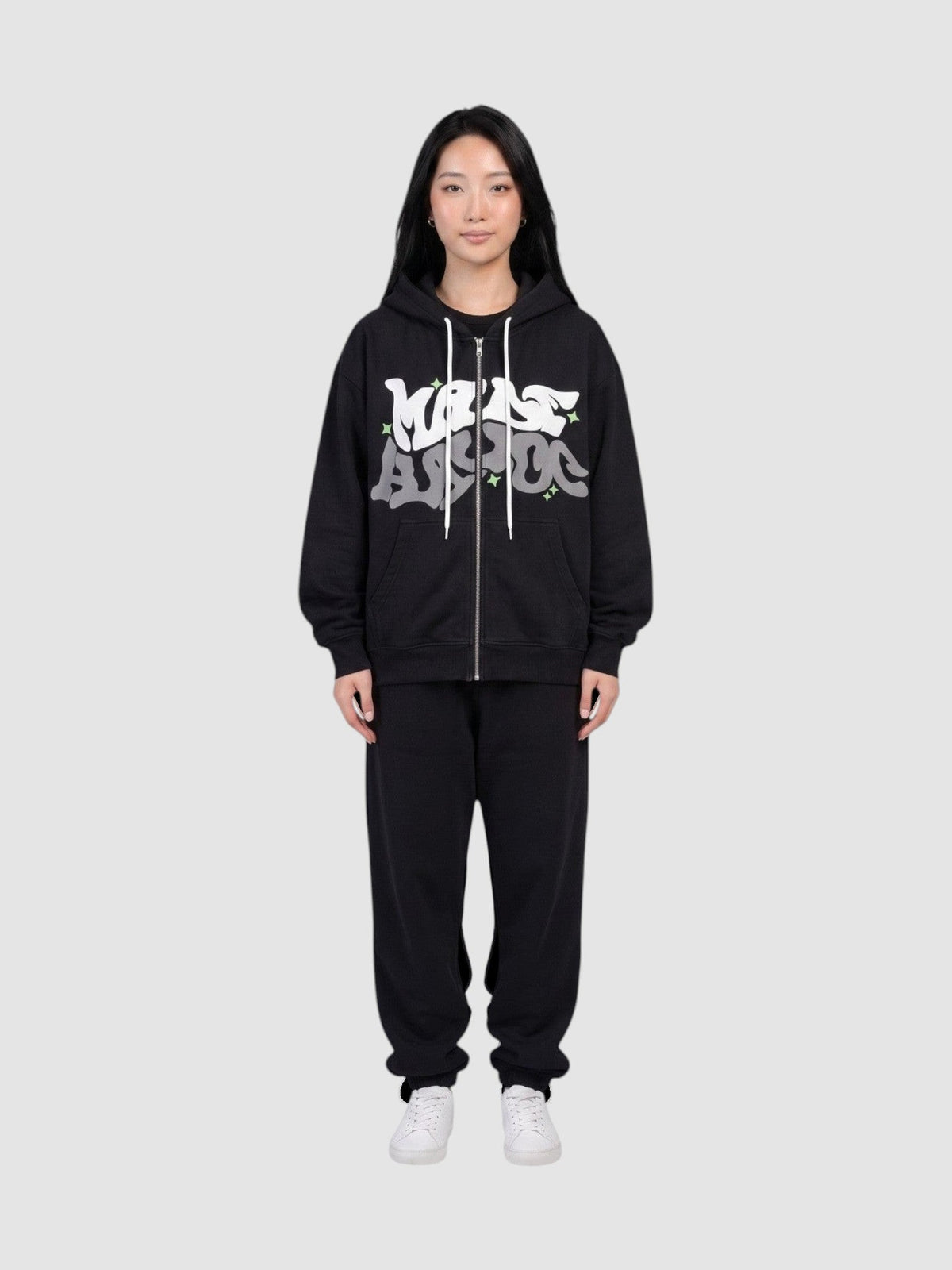 Y2K Avenue black zip-up hoodie with white and grey graffiti bubble lettering and green star accents on a model