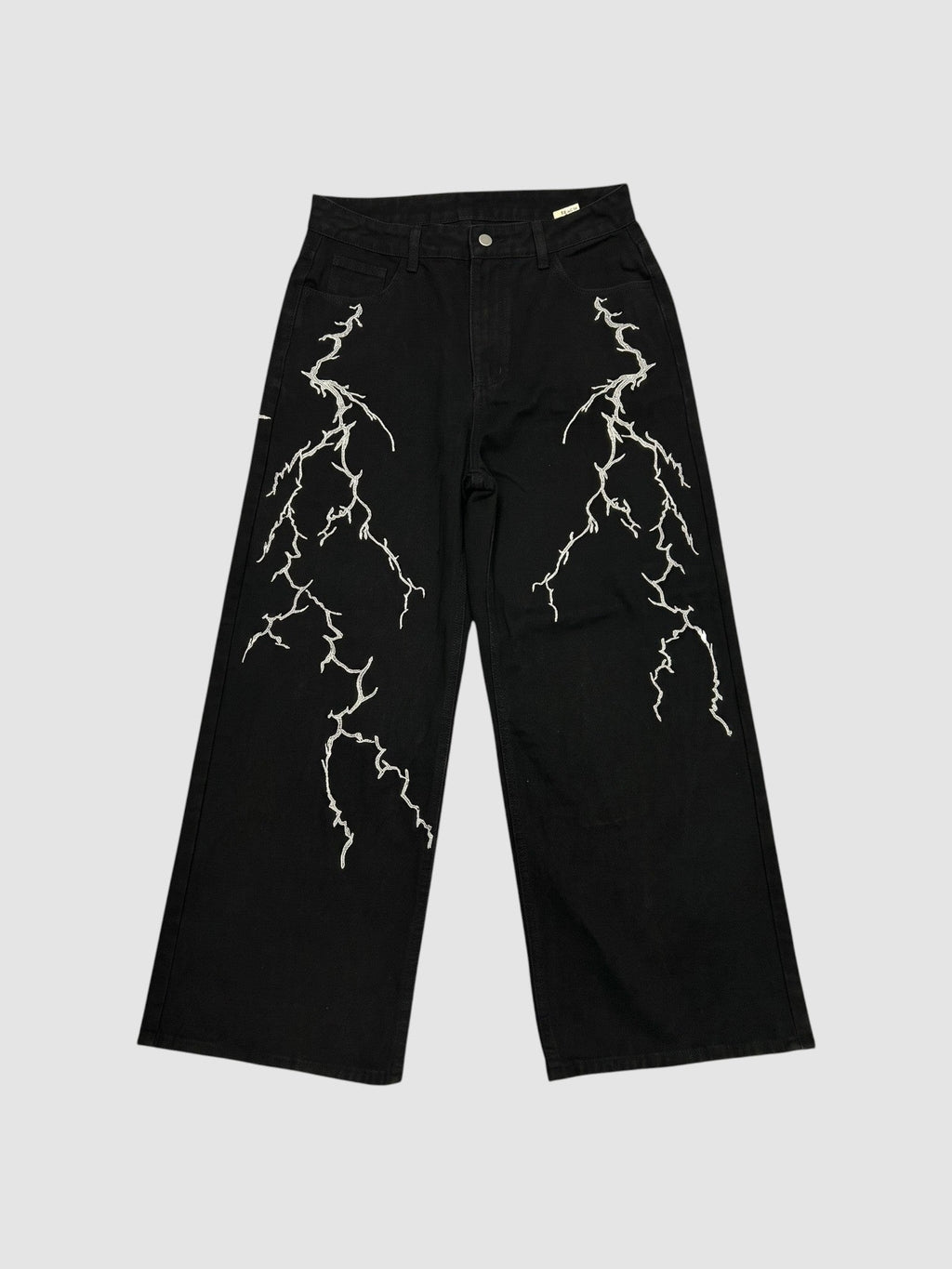 Y2K Avenue black wide-leg denim jeans featuring white embroidered lightning bolt patterns on both legs.