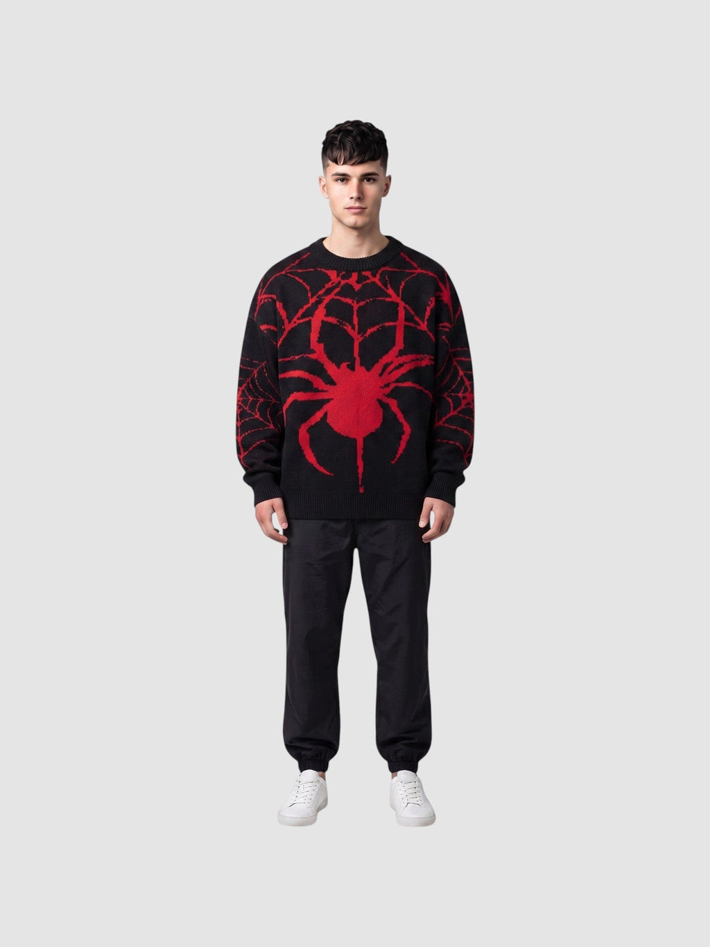 Y2K AVENUE black and red oversized knit sweater with a large embroidered spider design worn by a male model