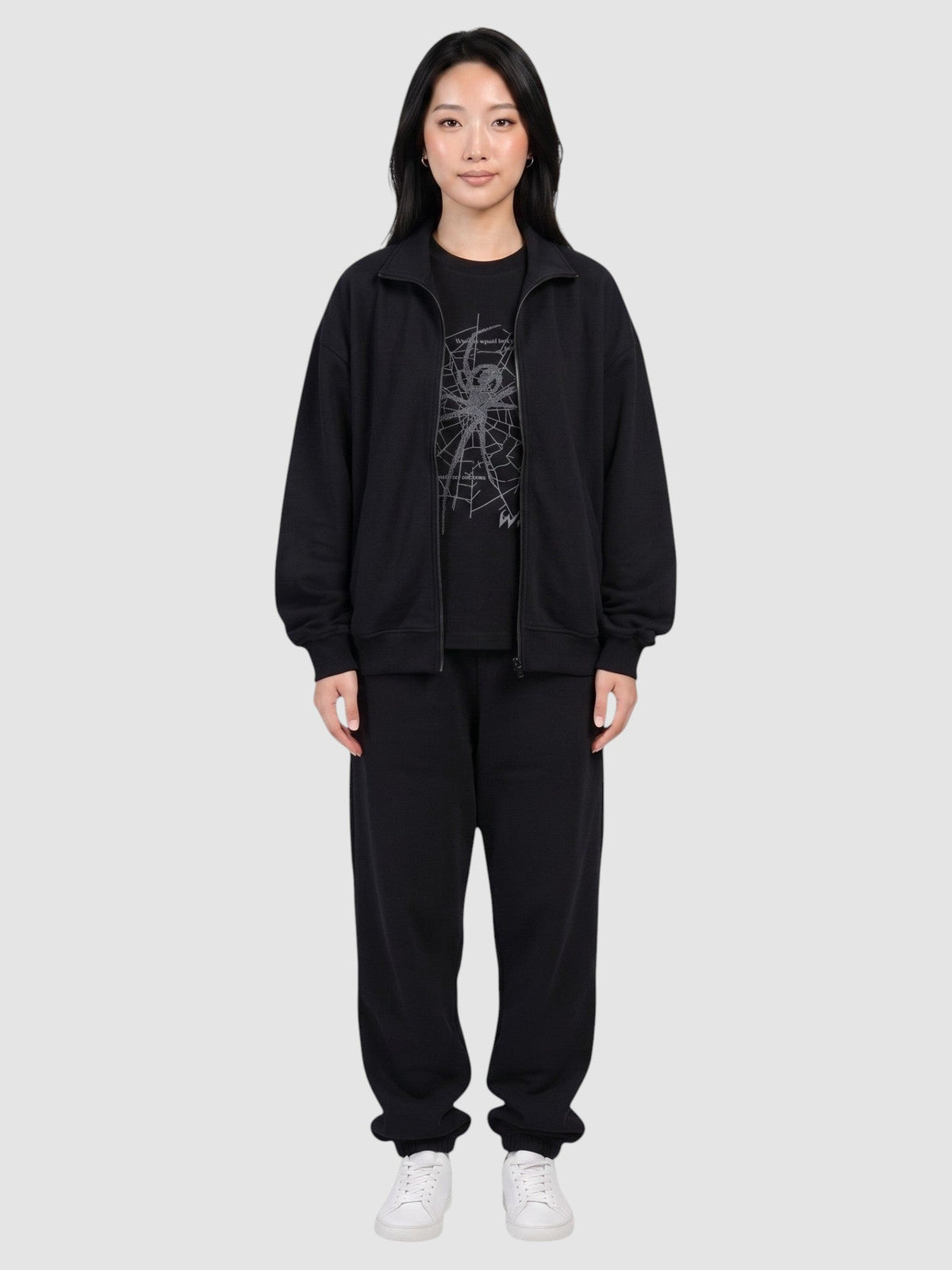 Y2K Avenue black oversized t-shirt with dark grey spider web print worn by a model in a matching tracksuit