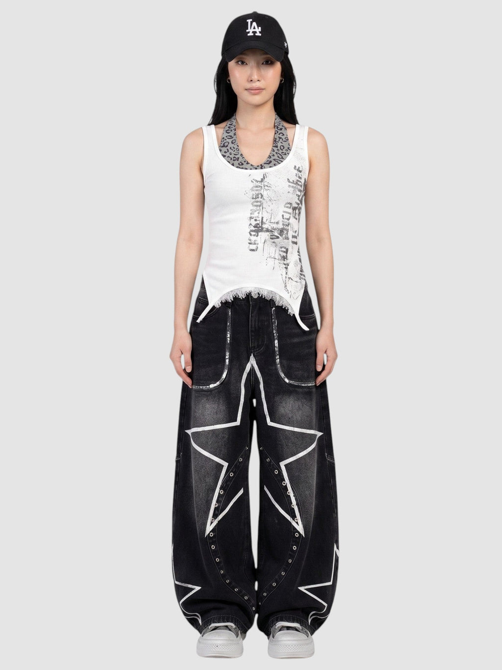 Y2K AVENUE baggy black wide leg jeans with white star prints and metal eyelets worn low-rise by a model
