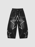 Y2K Avenue black baggy jeans with white hand-drawn star patterns, low-rise waist, and metallic eyelet detailing.