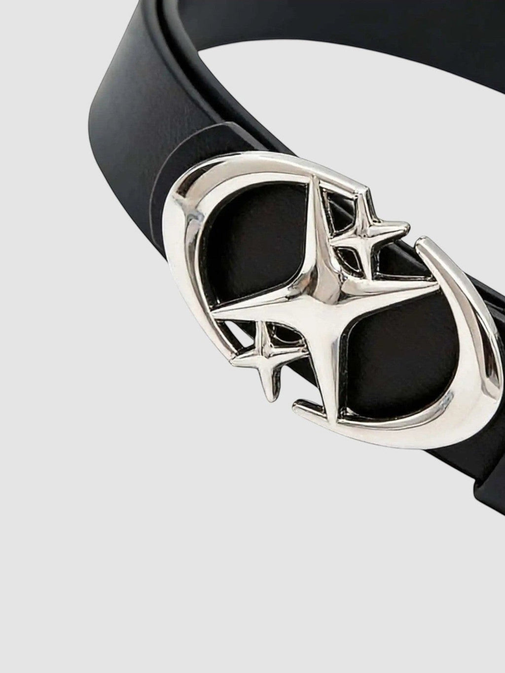 Y2K Avenue black faux leather belt featuring a shiny silver star-shaped buckle with curved crescent blade details.
