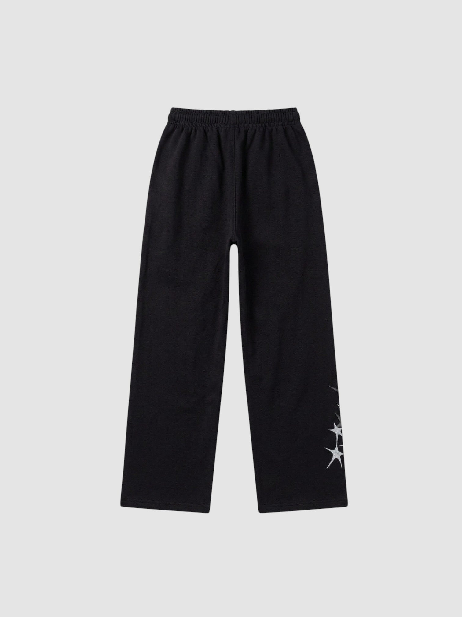 Y2K AVENUE black wide leg jogging pants with grey four-pointed star prints and an elastic drawstring waist.
