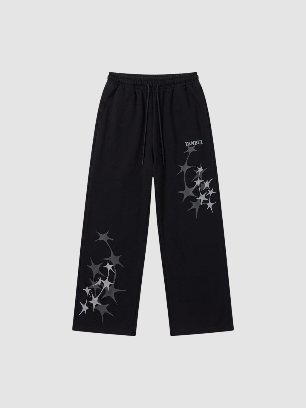 Y2K Avenue black wide leg sweatpants featuring grey four-pointed star prints and an elastic drawstring waistband.