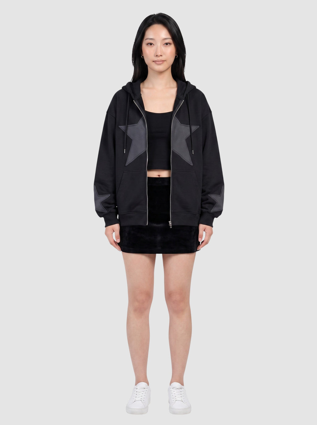 Y2K Avenue black oversized zip-up hoodie featuring a large stitched star patch on the chest and smaller star cuffs.