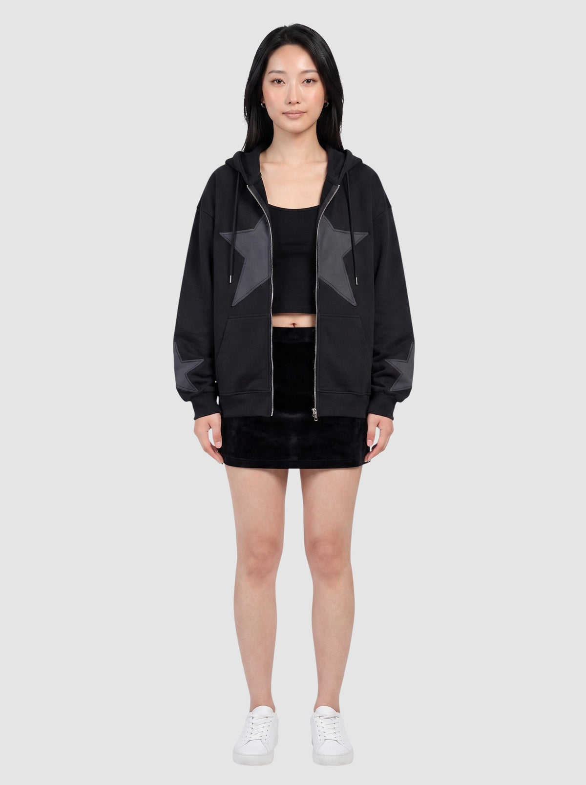 Y2K Avenue black oversized zip-up hoodie featuring a large stitched star patch on the chest and smaller star cuffs.