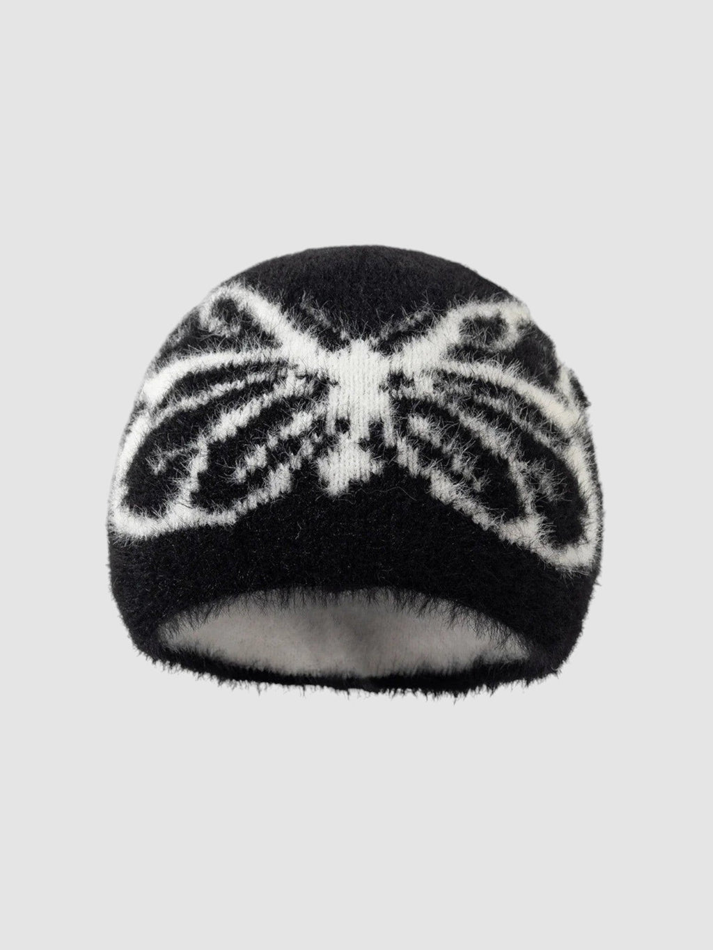 Y2K Avenue black and white fuzzy beanie with a butterfly wing pattern in a soft, plush texture.