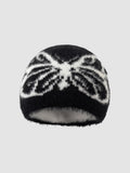Y2K Avenue black and white fuzzy beanie with a butterfly wing pattern in a soft, plush texture.