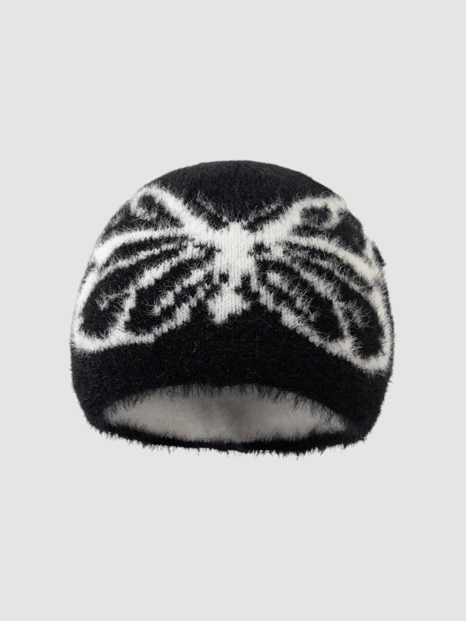 Y2K Avenue black and white fuzzy beanie with a butterfly wing pattern in a soft, plush texture.