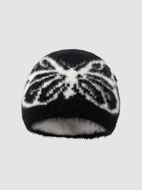 Y2K Avenue black and white fuzzy beanie with a butterfly wing pattern in a soft, plush texture.