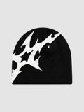 Y2K Avenue black acrylic beanie featuring an asymmetrical white stylized lightning bolt graphic pattern.