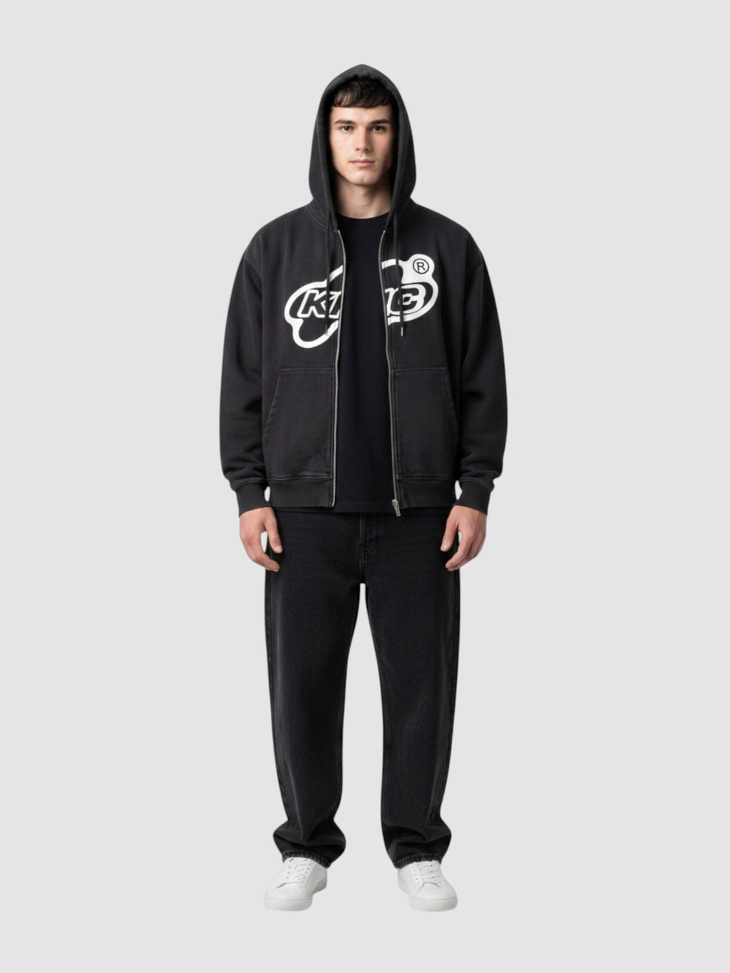 Y2K Avenue black zip-up hoodie with white bubble lettering logo, white trim, and oversized fit on a male model.