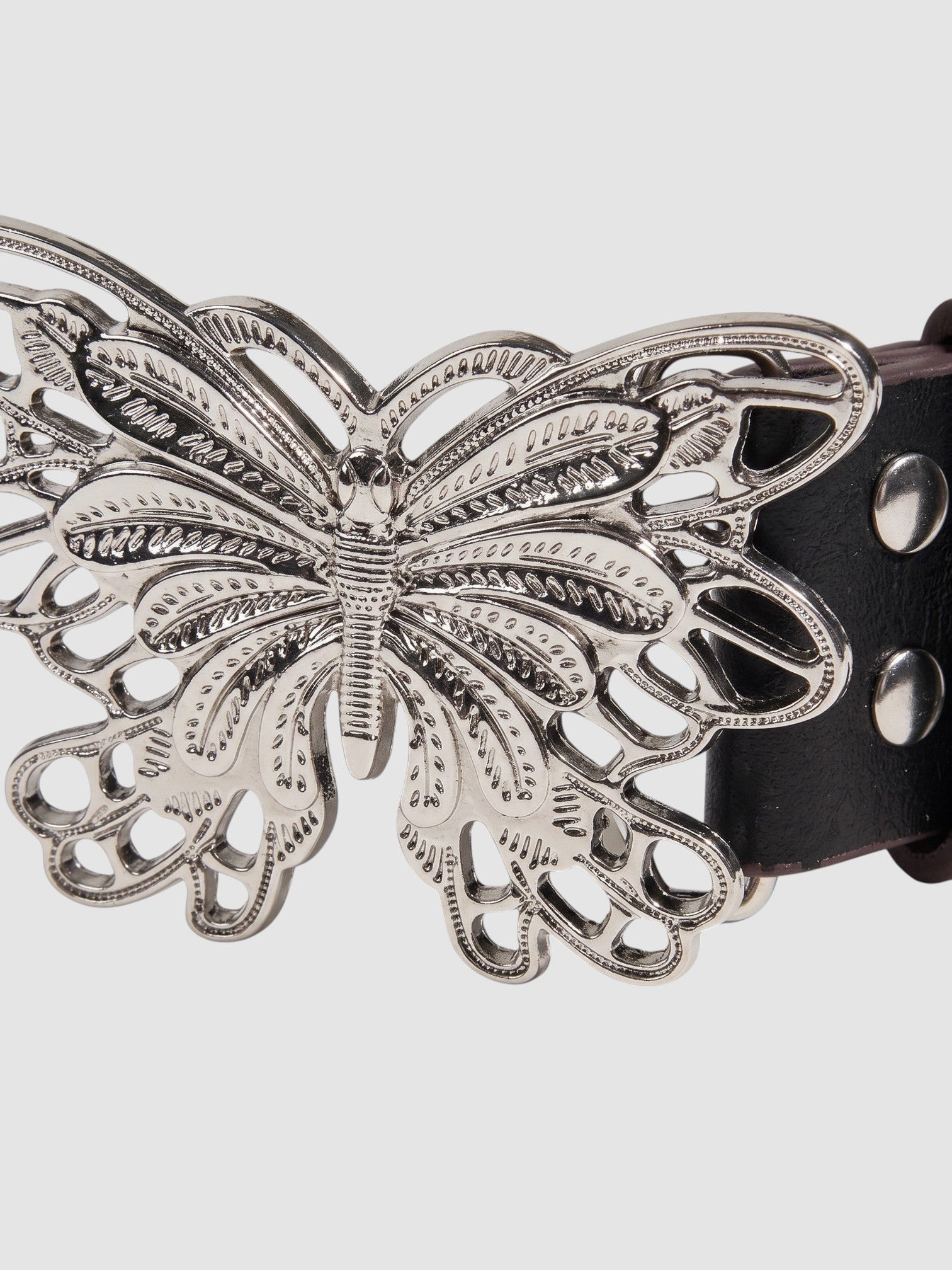 Y2K Avenue black faux leather belt featuring a detailed silver filigree butterfly buckle and metal rivets.