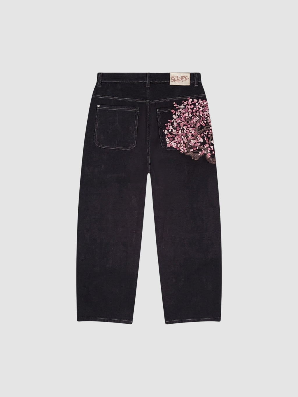 Y2K Avenue wide leg dark denim jeans featuring a detailed pink cherry blossom embroidery on the back right pocket.