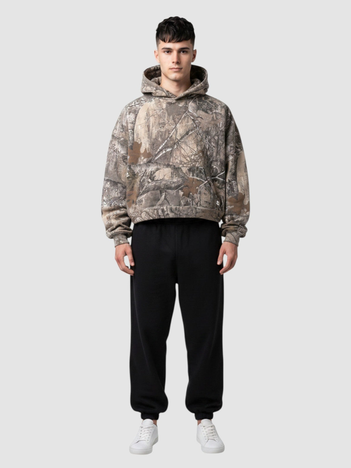 Y2K Avenue cropped camouflage hoodie with a tree bark print, oversized boxy fit, and ribbed cuffs on a male model.