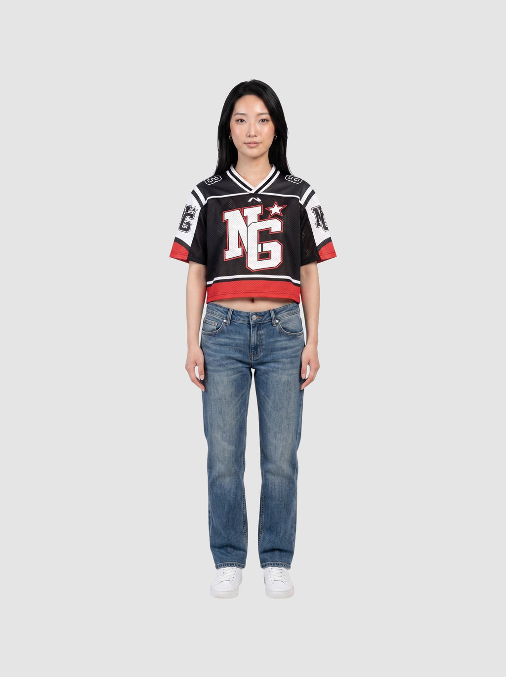 Y2K Avenue cropped black mesh football jersey with white shoulder panels, red trim, and graphic monogram print.
