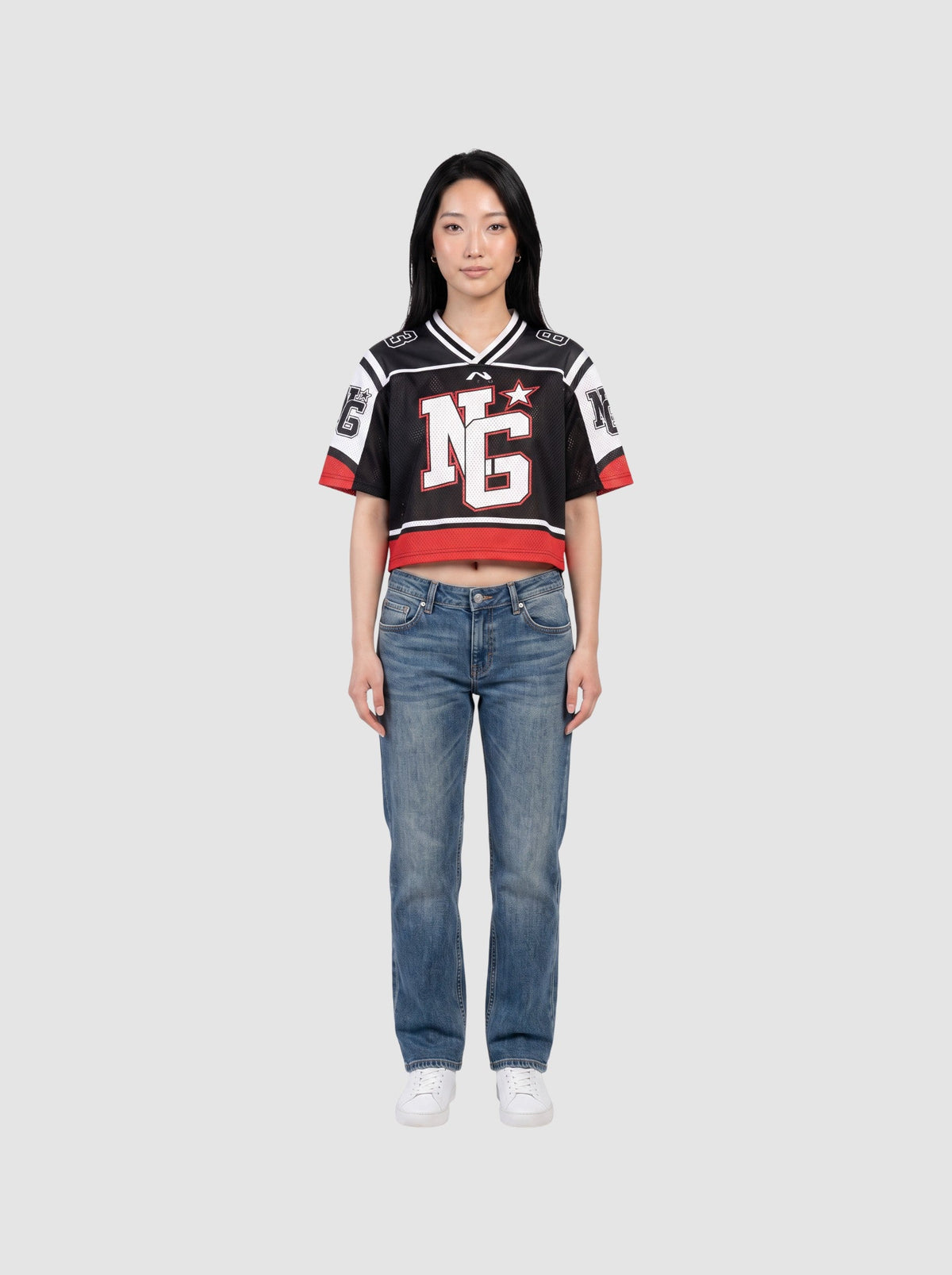 Y2K Avenue cropped black mesh football jersey with white shoulder panels, red trim, and graphic monogram print.