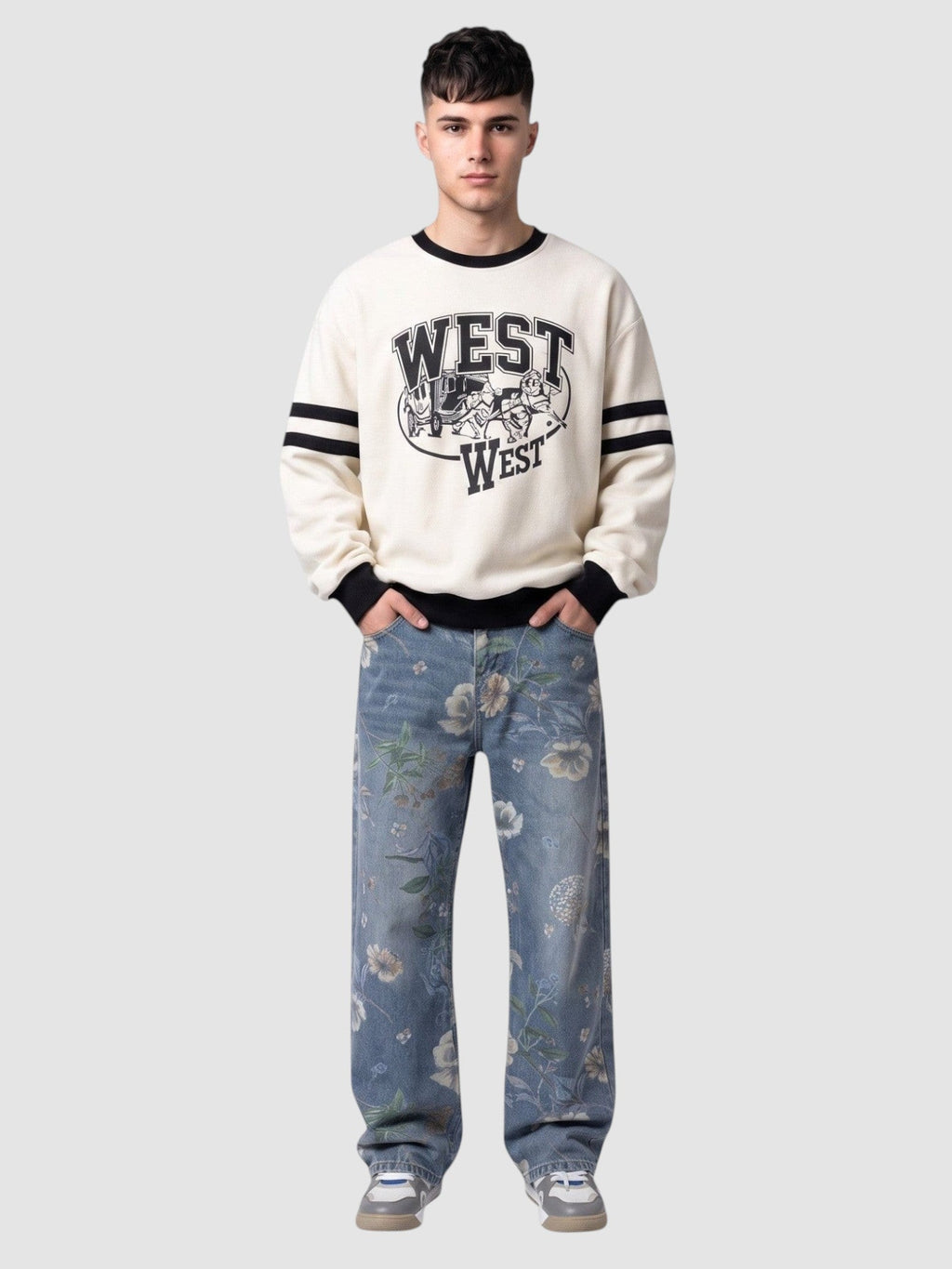 Y2K Avenue light blue carpenter jeans with watercolor floral print worn by a man in a cream graphic sweatshirt.