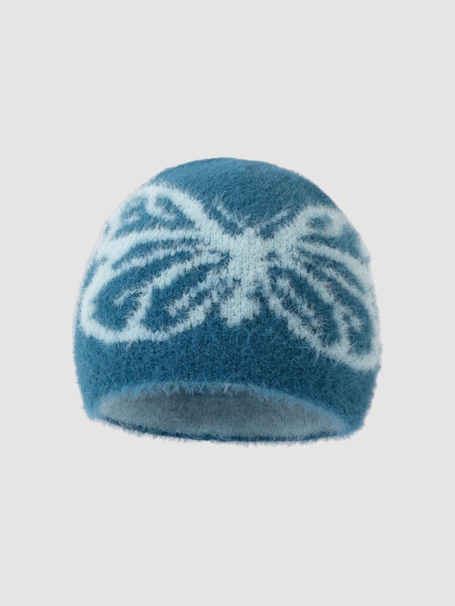 Y2K Avenue fuzzy blue beanie with a white butterfly wing pattern, featuring a soft plush texture and cozy fit.