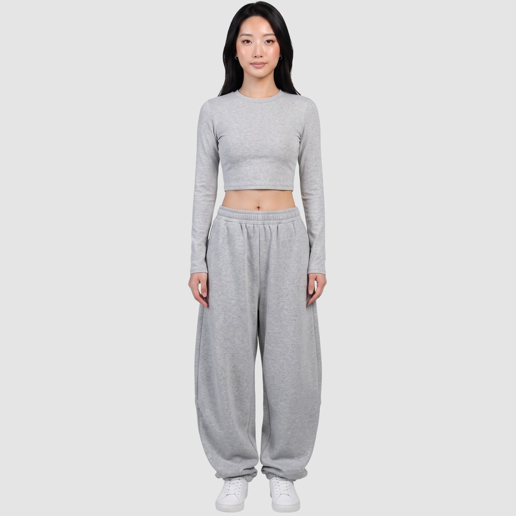 Y2K AVENUE grey barrel leg sweatpants with a high elastic waist and relaxed fit worn by a model with a crop top.