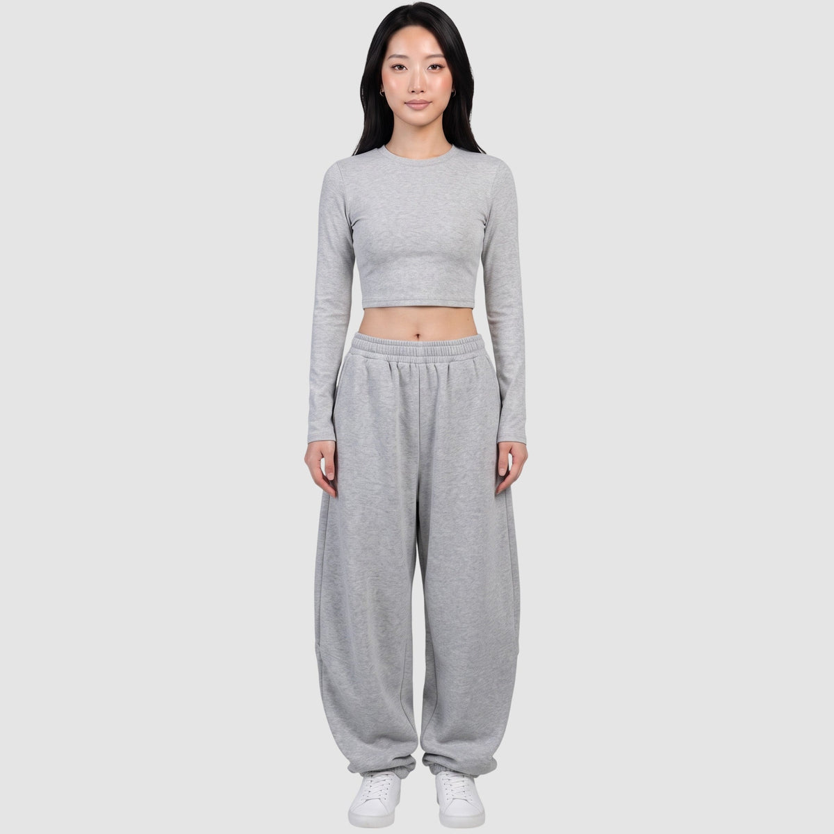 Y2K AVENUE grey barrel leg sweatpants with a high elastic waist and relaxed fit worn by a model with a crop top.