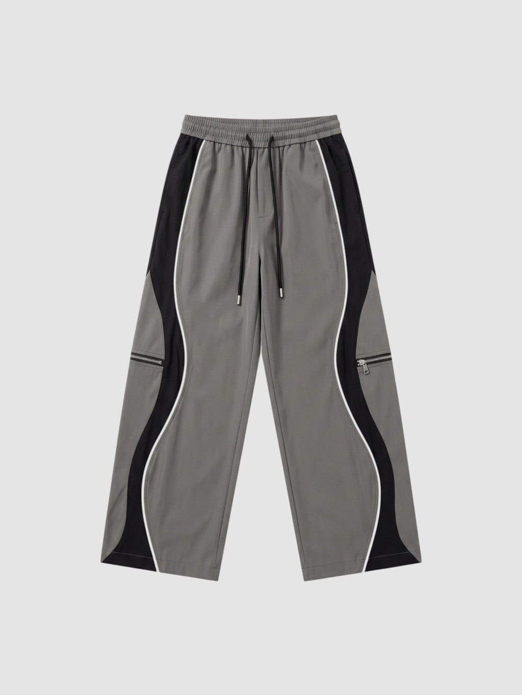 Y2K AVENUE grey and black panelled Y2K trousers with white piping, decorative zippers, and adjustable ankle cords.